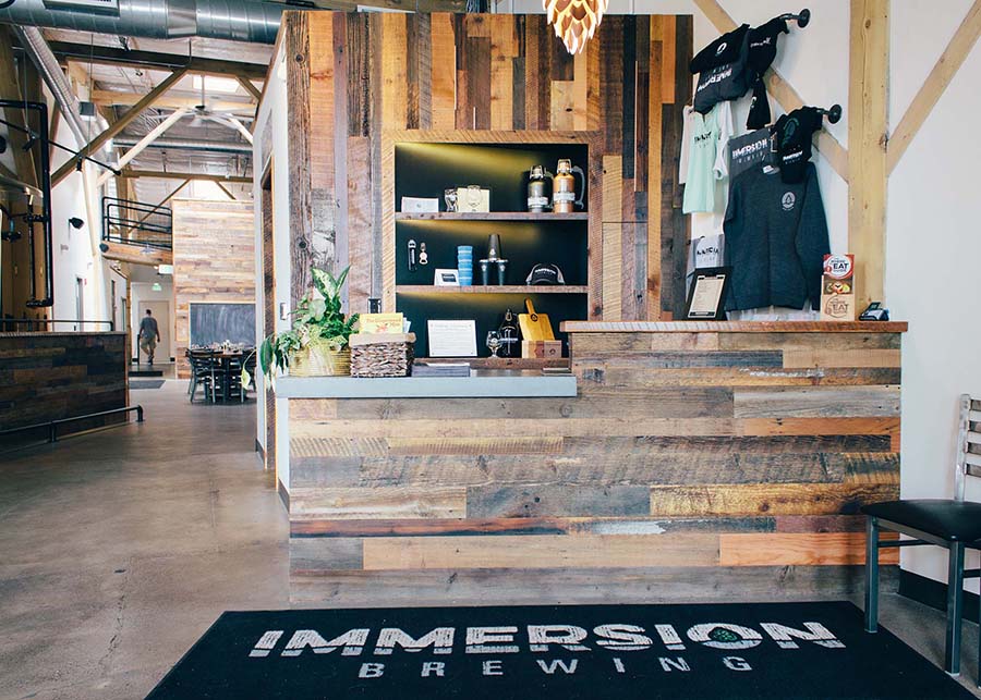 The entryway to Immersion Brewing. A small retail area and hostess stand was constructed using vinegar washed planks